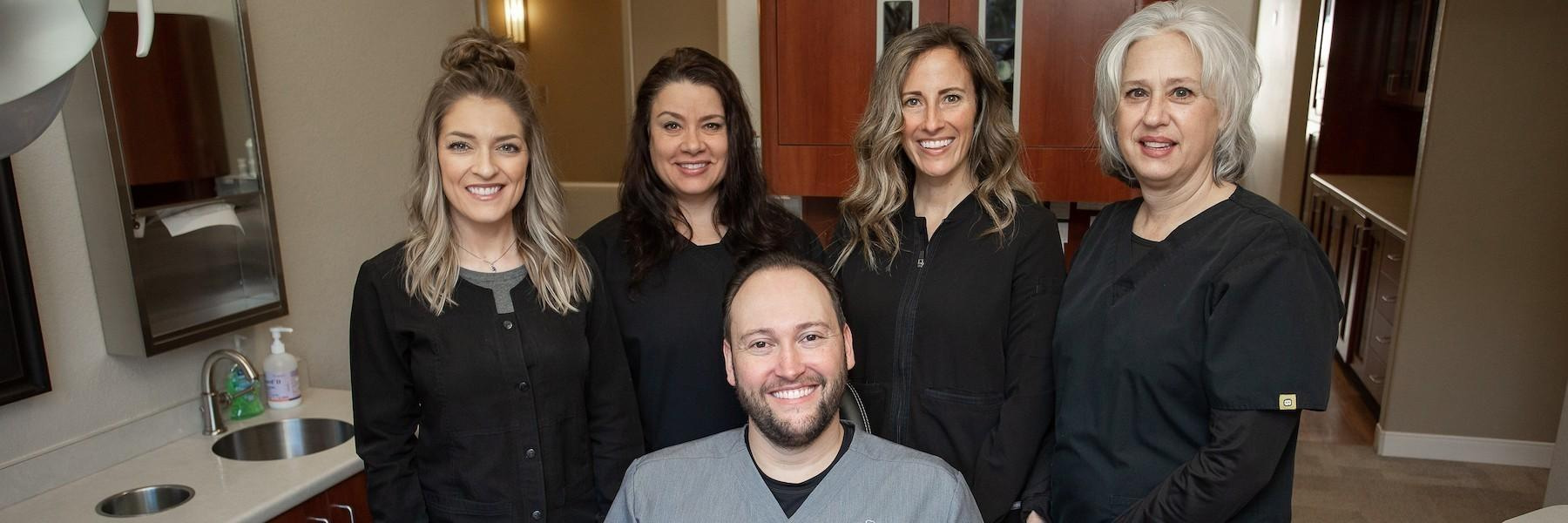 Group of men and women smiling | Dentist in Lead SD